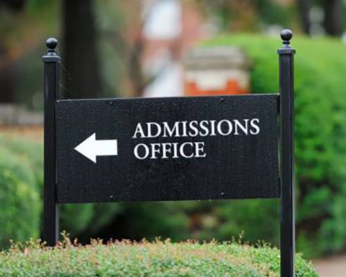 Close up of admissions office sign near public university campus